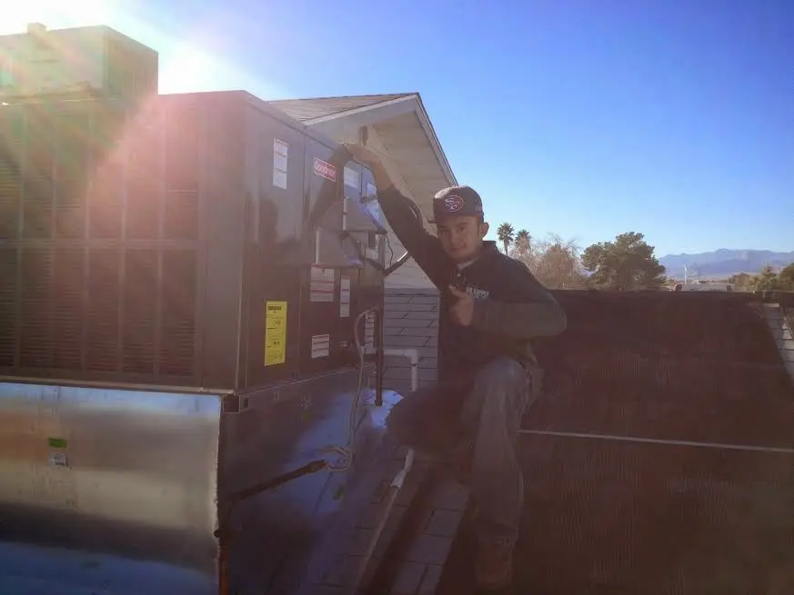 HVAC technician performing HVAC Inspection on a rooftop unit in Aberdeen